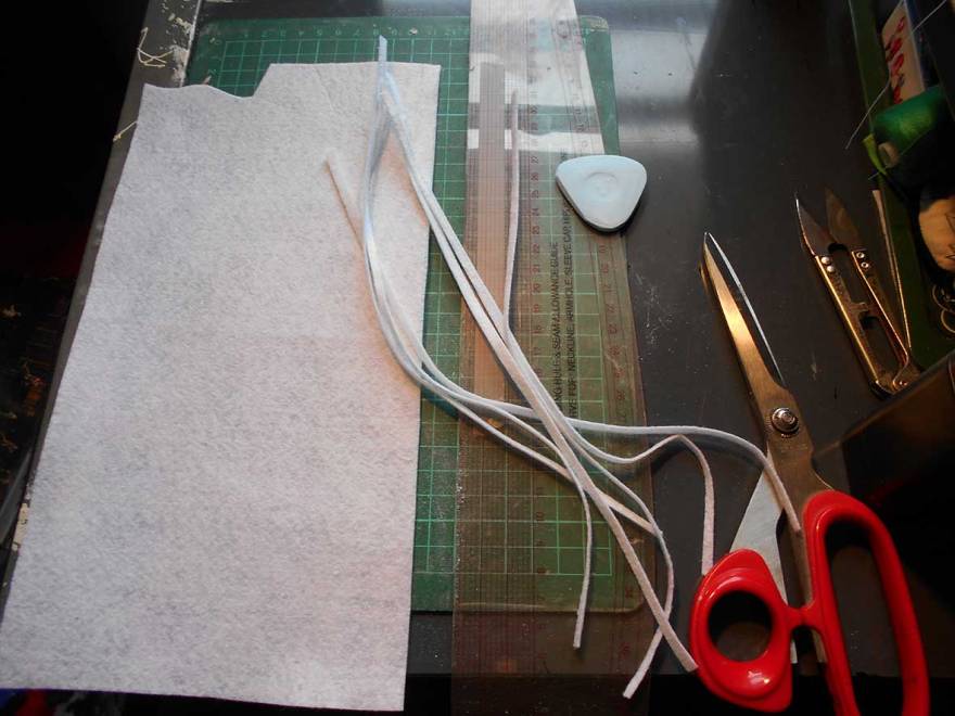 White felt is cut into strips for a sewing project