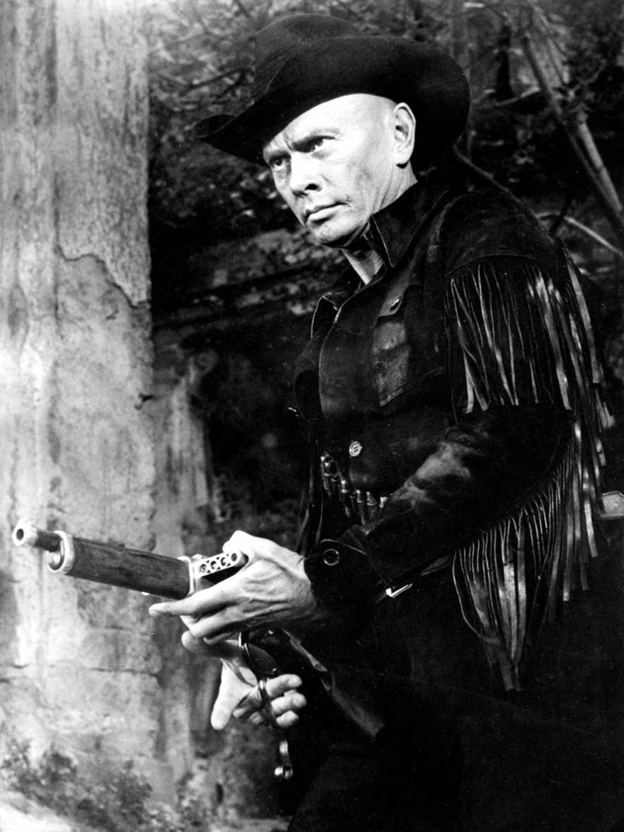 Actor Yul Brynner in a black cowboy outfit